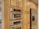 Kitchen with stainless steel double oven, stainless steel refrigerator and wood cabinets at 5529 Five Knolls Dr, Charlotte, NC 28226