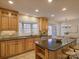 Spacious kitchen features light wood cabinets, island with seating, granite countertops, and stainless steel appliances at 5529 Five Knolls Dr, Charlotte, NC 28226