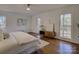 Sun-filled main bedroom with hardwood floors, three large windows and wood accent dresser at 5529 Five Knolls Dr, Charlotte, NC 28226