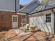 Outdoor patio space with brick floor, white doors, light blue siding, and stylish outdoor seating at 5529 Five Knolls Dr, Charlotte, NC 28226