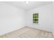 Bright and airy bedroom with neutral carpeting and a large window at 5633 Torrence St, Charlotte, NC 28269