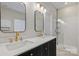 Modern bathroom with double vanity and gold fixtures at 6415 Outer Bridge Ln, Charlotte, NC 28270