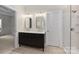 Modern bathroom with double vanity and gold fixtures at 6415 Outer Bridge Ln, Charlotte, NC 28270