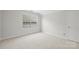 Well-lit bedroom featuring carpet and window at 6415 Outer Bridge Ln, Charlotte, NC 28270