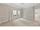 Bright bedroom with neutral walls and carpet, access to kitchen at 6415 Outer Bridge Ln, Charlotte, NC 28270