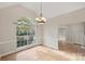 Formal dining room with hardwood floors and arched window at 6415 Outer Bridge Ln, Charlotte, NC 28270