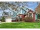 Brick and light blue two-story house with a spacious lawn at 6415 Outer Bridge Ln, Charlotte, NC 28270