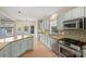 Kitchen boasting light-blue cabinets, granite countertops and stainless steel appliances at 6415 Outer Bridge Ln, Charlotte, NC 28270