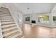 Living room with vaulted ceiling, hardwood floors, and fireplace at 6415 Outer Bridge Ln, Charlotte, NC 28270