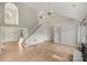 Bright living area with hardwood floors, staircase, and built-in shelves at 6415 Outer Bridge Ln, Charlotte, NC 28270