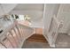 View of staircase overlooking living area and kitchen at 6415 Outer Bridge Ln, Charlotte, NC 28270