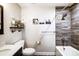 Modern bathroom with a shower/tub combo and wood-look tile at 703 Southwest Dr, Davidson, NC 28036