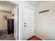 Interior entryway with door to bedroom and coat rack at 703 Southwest Dr, Davidson, NC 28036