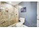 Walk-in shower with stone tile and pebble floor at 703 Southwest Dr, Davidson, NC 28036