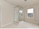 Contemporary bathroom featuring frameless shower and marble-look tile at 8022 Franklin Trail St, Mint Hill, NC 28227