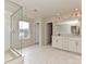 Bright bathroom boasting glass enclosed shower, double vanity, and gorgeous tile flooring at 8022 Franklin Trail St, Mint Hill, NC 28227