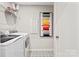 Laundry room featuring sleek washer and dryer, geometric tile flooring and wire shelving at 8022 Franklin Trail St, Mint Hill, NC 28227