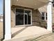 This covered brick patio includes a sliding glass door and white columns at 8022 Franklin Trail St, Mint Hill, NC 28227