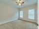 Bright bedroom with neutral carpeting and two large windows at 810 Carisbrooke Ln, Waxhaw, NC 28173