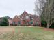 Two-story brick home with a large front yard and mature trees at 810 Carisbrooke Ln, Waxhaw, NC 28173