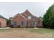 Two-story brick home with a front porch and green door at 810 Carisbrooke Ln, Waxhaw, NC 28173