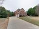 Brick house with a two-car garage and a landscaped yard at 810 Carisbrooke Ln, Waxhaw, NC 28173