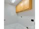 Laundry room with wood cabinets and tile floor at 810 Carisbrooke Ln, Waxhaw, NC 28173