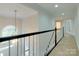 Upper hall with carpet, railing, and chandelier at 810 Carisbrooke Ln, Waxhaw, NC 28173