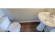 Small bathroom with pedestal sink and toilet at 13406 Tartarian Ct, Charlotte, NC 28215