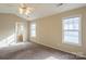 Bright bedroom with en-suite bathroom access and ceiling fan at 13406 Tartarian Ct, Charlotte, NC 28215