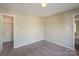 Bright bedroom with carpet, ceiling fan, and spacious closet at 13406 Tartarian Ct, Charlotte, NC 28215