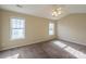 Spacious bedroom with two windows, carpet, and ceiling fan at 13406 Tartarian Ct, Charlotte, NC 28215