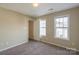 Well-lit bedroom with two windows and closet at 13406 Tartarian Ct, Charlotte, NC 28215