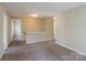 Upstairs hallway with carpeted floor and doors to bedrooms at 13406 Tartarian Ct, Charlotte, NC 28215