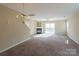 Living room with fireplace, sliding door, and chandelier at 13406 Tartarian Ct, Charlotte, NC 28215