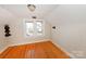 Small attic bedroom with hardwood floors and two windows at 1909 2Nd Sw Ave, Hickory, NC 28602