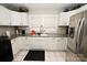 White cabinets and granite countertops in this well-lit kitchen at 1909 2Nd Sw Ave, Hickory, NC 28602