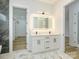 Double vanity bathroom with marble-look floors and a large mirror at 2005 Plain Field Dr, Bessemer City, NC 28016