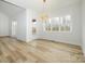 Spacious dining area with hardwood floors, a large window, and a modern chandelier at 2005 Plain Field Dr, Bessemer City, NC 28016