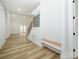 Bright and airy foyer with light wood-look floors, built-in bench, and staircase with metal railing at 2005 Plain Field Dr, Bessemer City, NC 28016