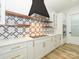 Modern kitchen with white cabinets, quartz countertops, and geometric backsplash at 2005 Plain Field Dr, Bessemer City, NC 28016