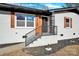 Modern front entry with stylish metal railing and wood accents at 2108 Sherwood Forest Ln, Monroe, NC 28110