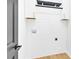 Laundry room with white shiplap walls, cabinets, and a hanging rod at 2108 Sherwood Forest Ln, Monroe, NC 28110