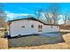 Home's back features sliding doors, patio, and a spacious yard at 2108 Sherwood Forest Ln, Monroe, NC 28110