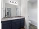 Bathroom boasts a vanity with granite countertop and blue cabinets at 2754 Crowders Creek Rd, Gastonia, NC 28052