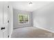 Simple bedroom with carpeted floor and a window at 2754 Crowders Creek Rd, Gastonia, NC 28052