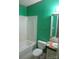 This bathroom features green painted walls, a white toilet and bathtub, and a wood-look counter at 3958 Benny Shrum Ln, Maiden, NC 28650