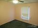 This bedroom features a ceiling fan, green carpet, a window with blinds, and light pink painted walls at 3958 Benny Shrum Ln, Maiden, NC 28650