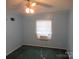 This bedroom features a ceiling fan, green carpet, a window, and light blue painted walls at 3958 Benny Shrum Ln, Maiden, NC 28650