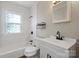 This bathroom features a vanity, toilet and bathtub with tiled walls and a privacy window at 503 N Boyce St, Gastonia, NC 28052